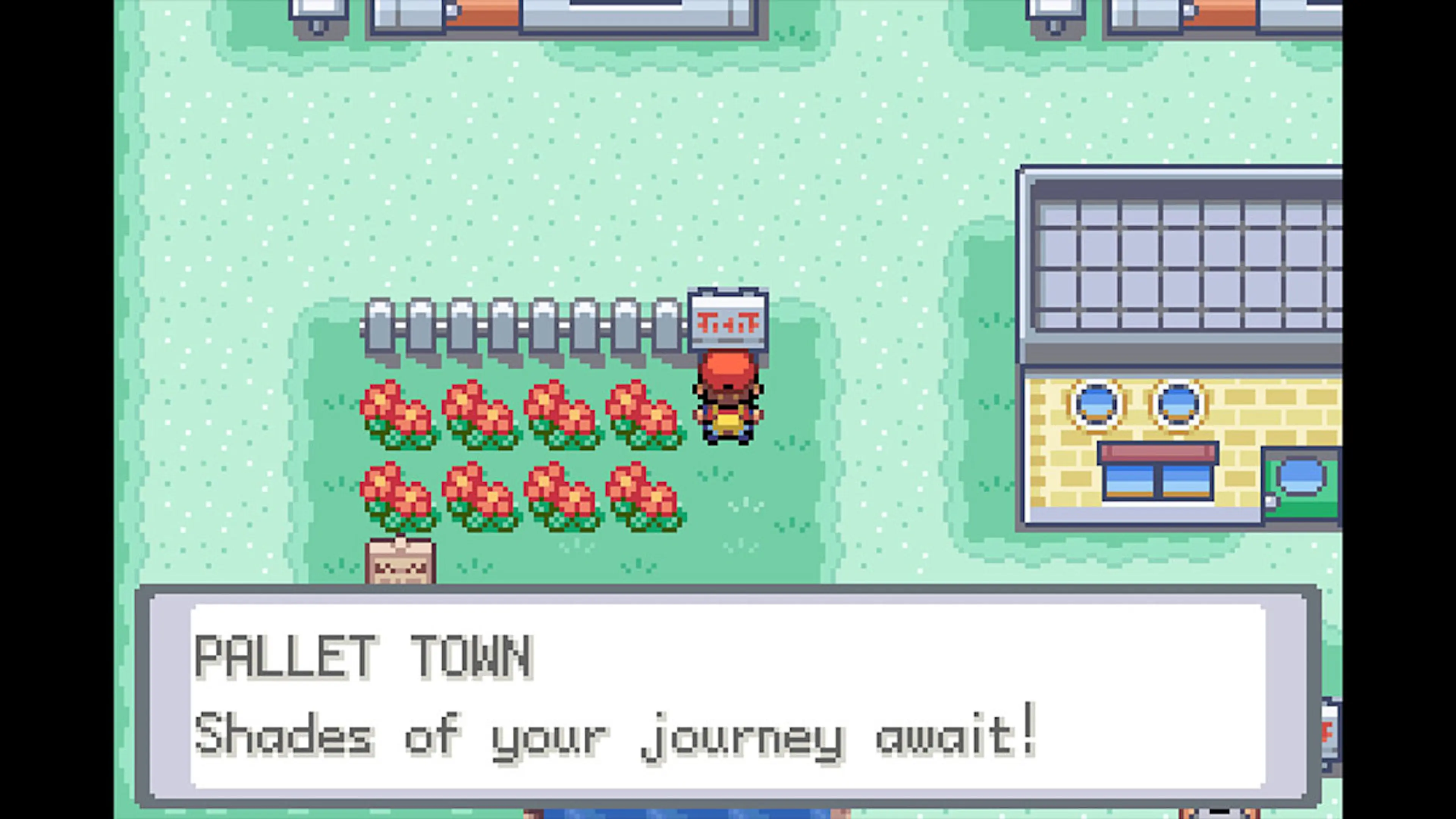 The player reads a sign in Pallet Town beside Professor Oak’s laboratory.