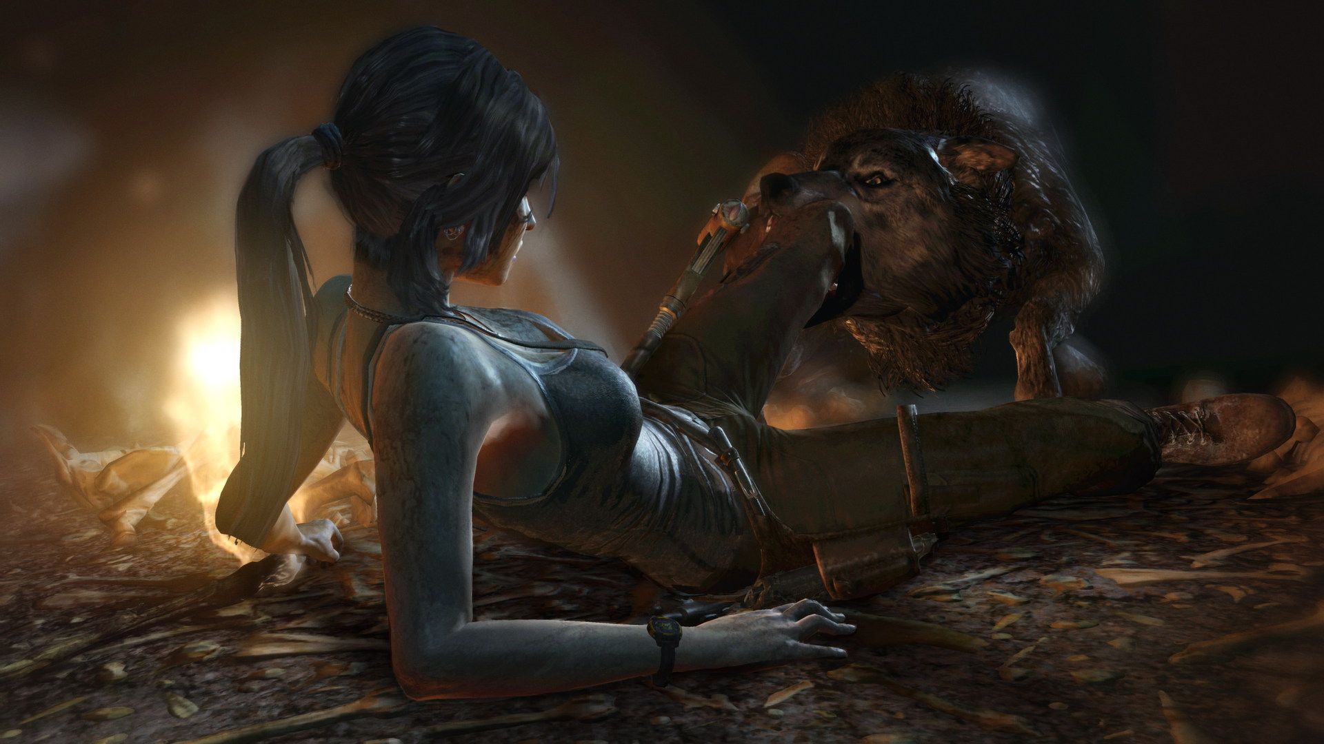 Lara struggles against a wild animal in a dark place.