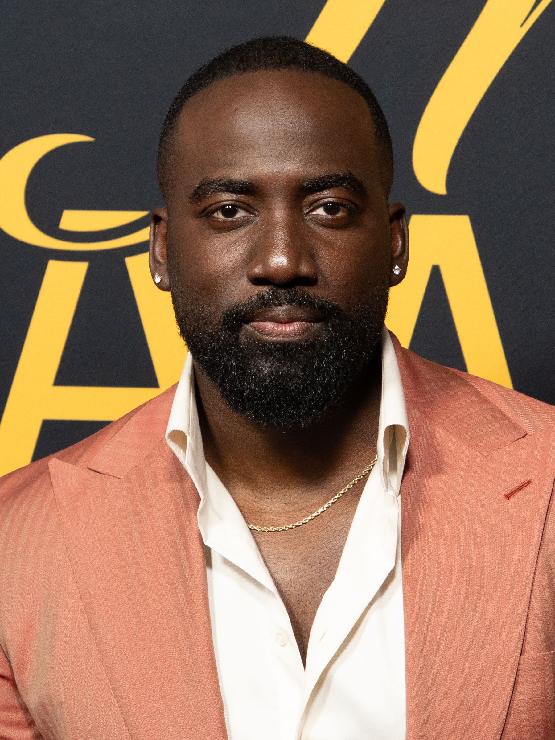 Shamier Anderson in a coral jacket at the 2026 Toronto International Film Festival.