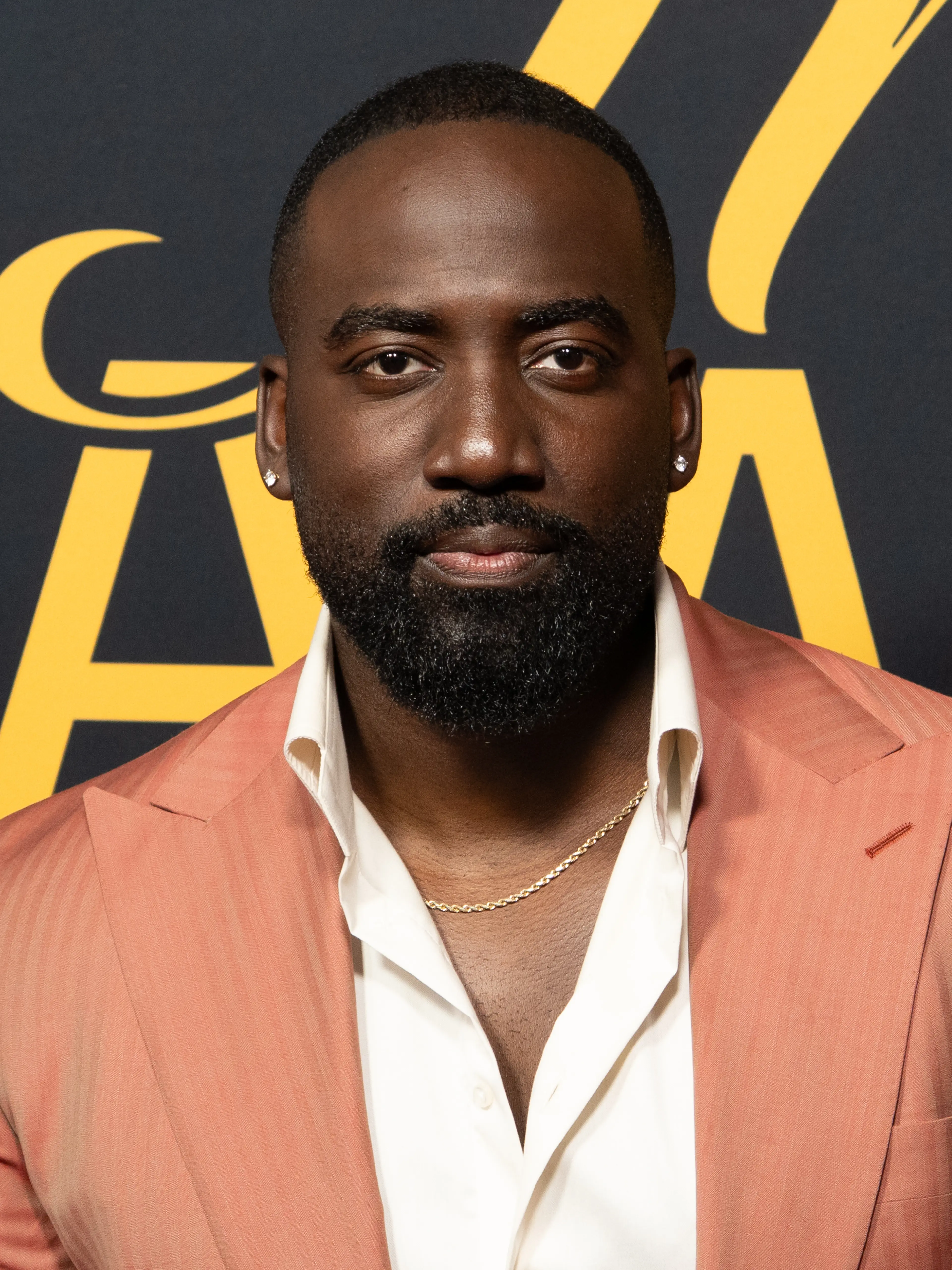 Shamier Anderson in a coral jacket at the 2026 Toronto International Film Festival.