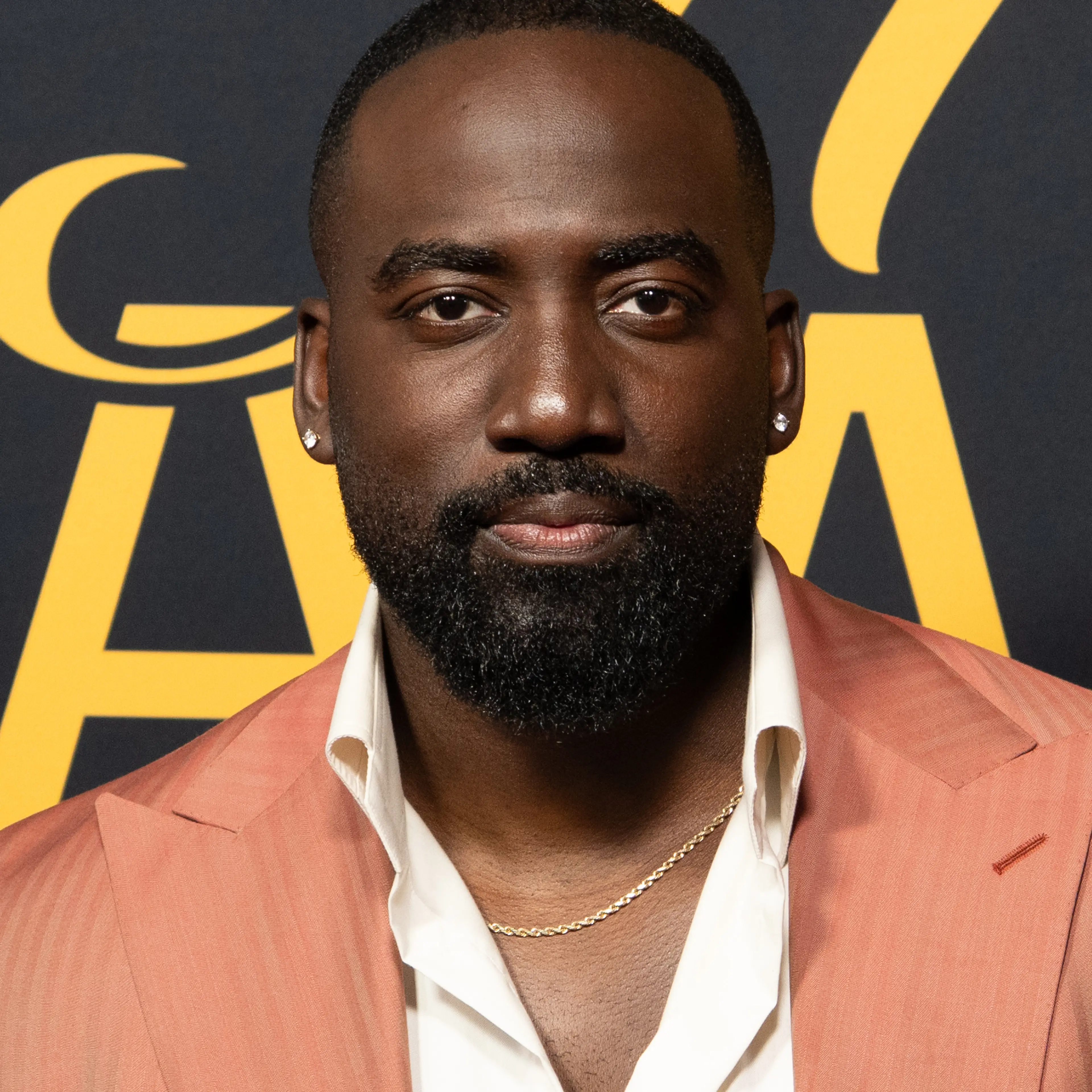 Shamier Anderson in a coral jacket at the 2026 Toronto International Film Festival.