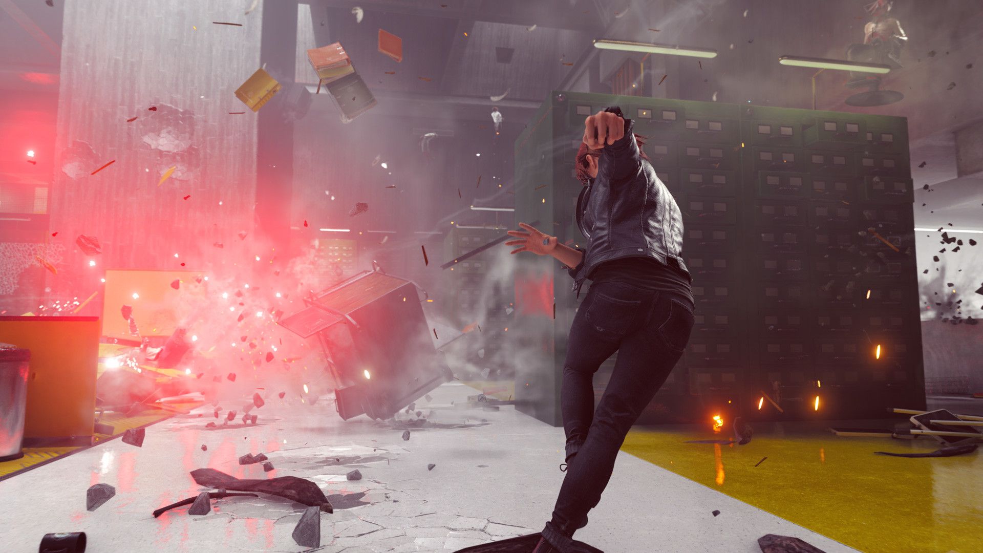 Jesse fights in an office filled with red light and floating debris.