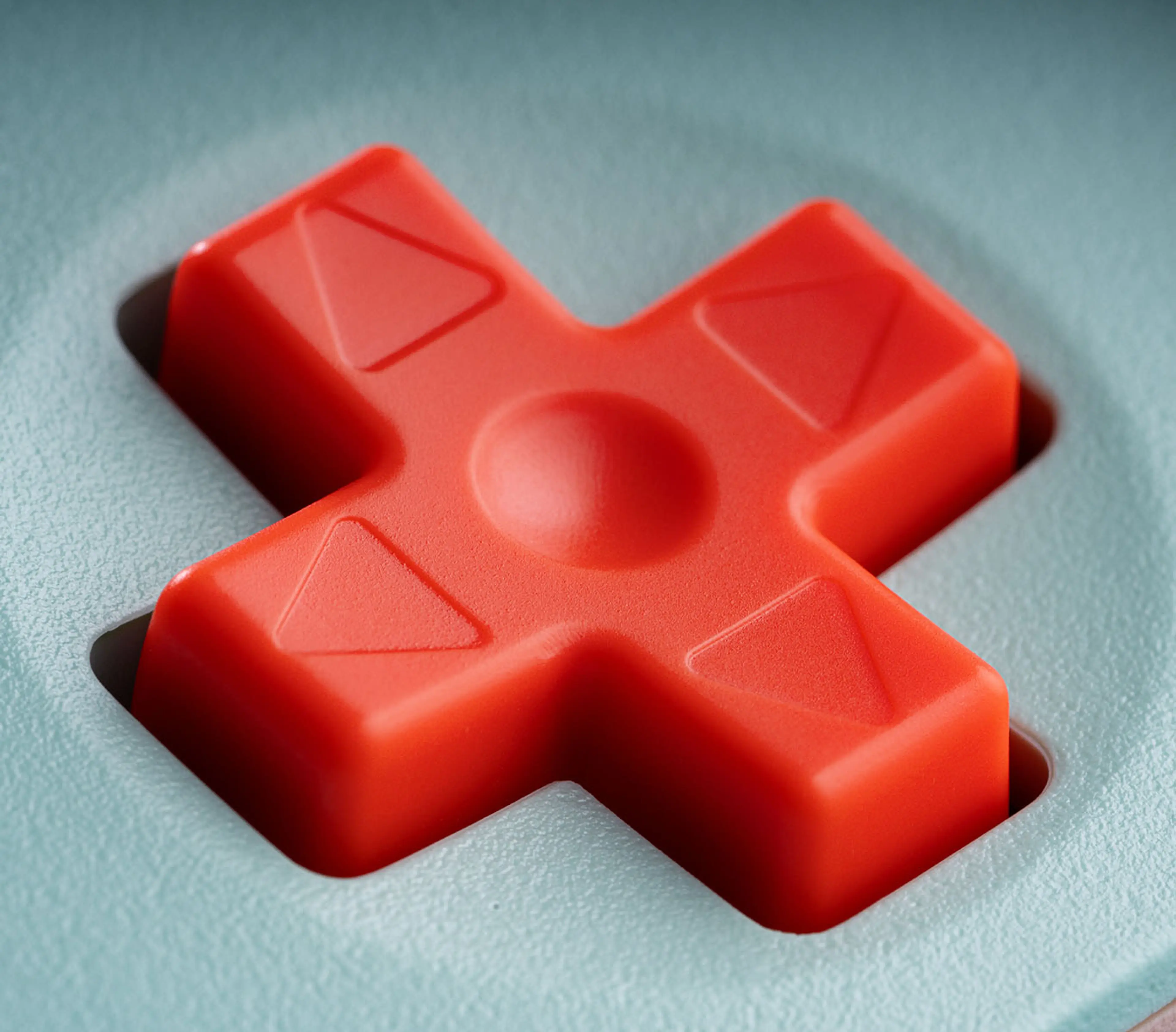 Close-up of the coral directional pad on the Mint Ultimate 2C Wireless