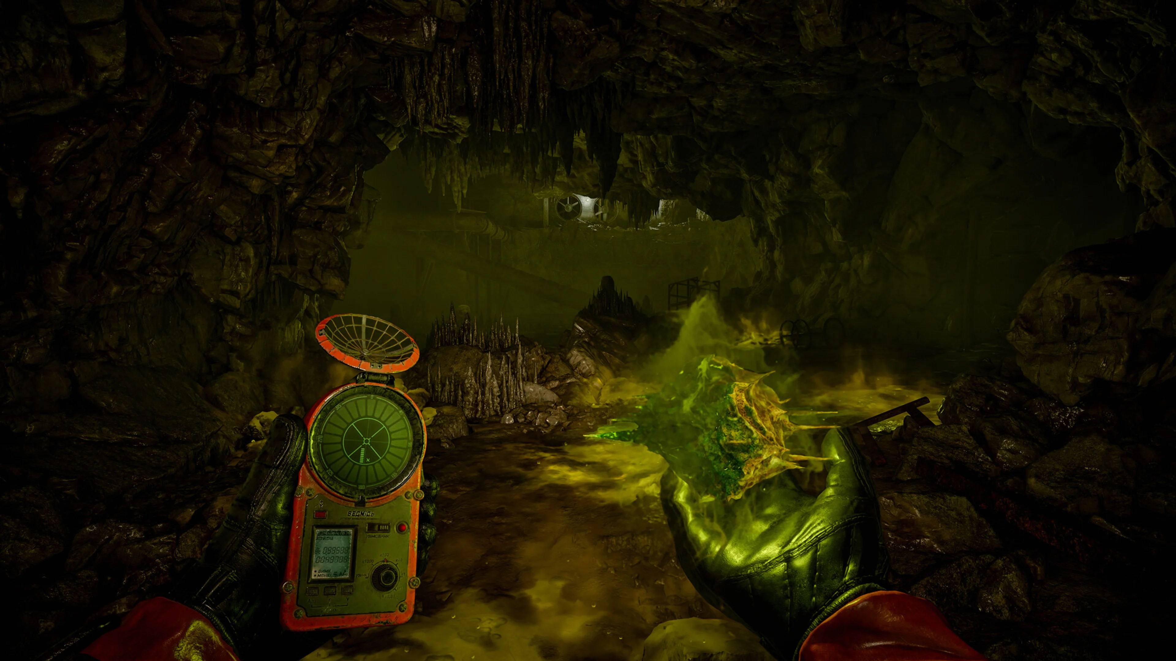 A stalker holding an artifact detector beside a glowing anomaly in a cave in S.T.A.L.K.E.R. 2.