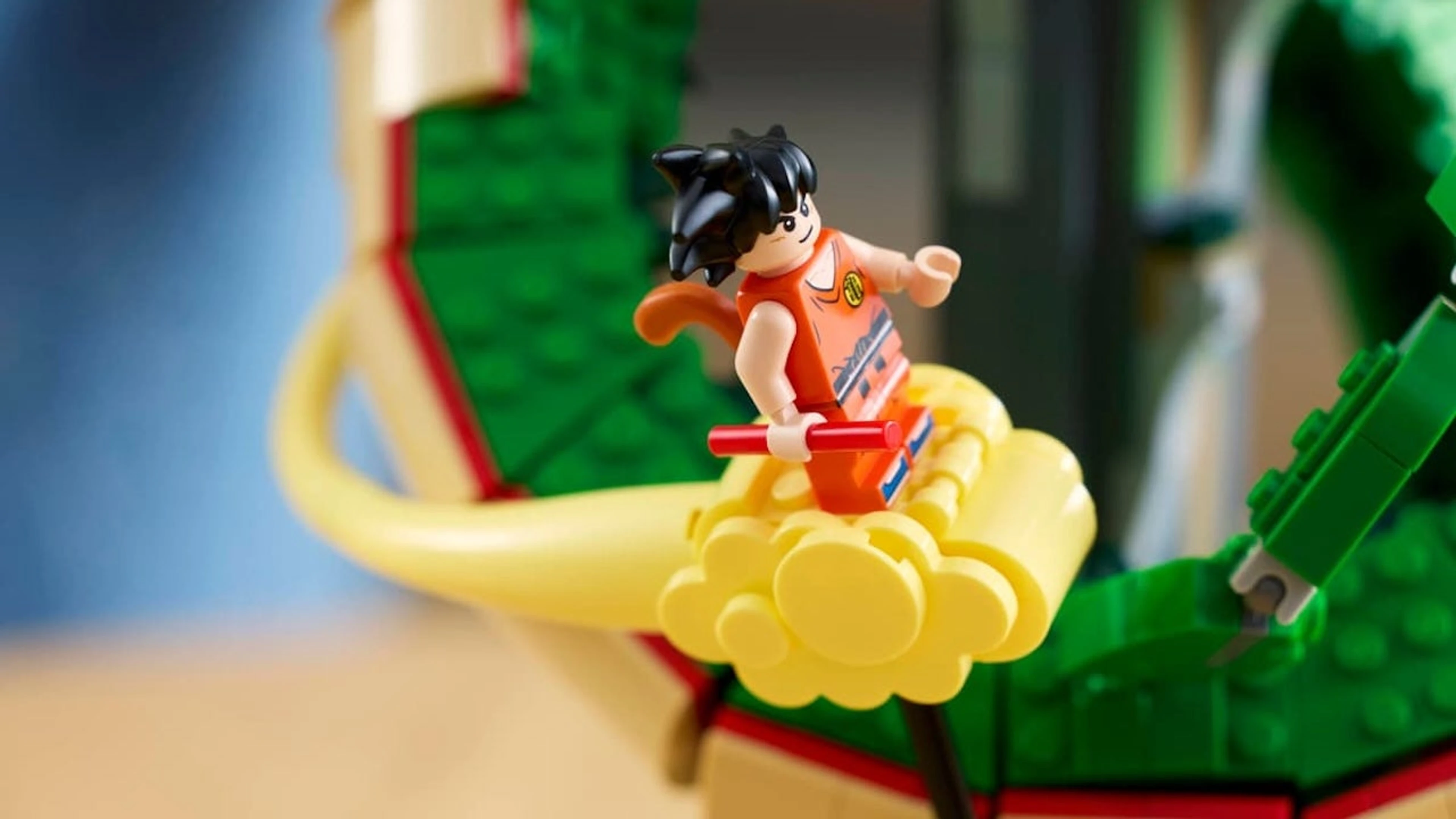 LEGO Kid Goku rides the Flying Nimbus in front of a large Shenron model.