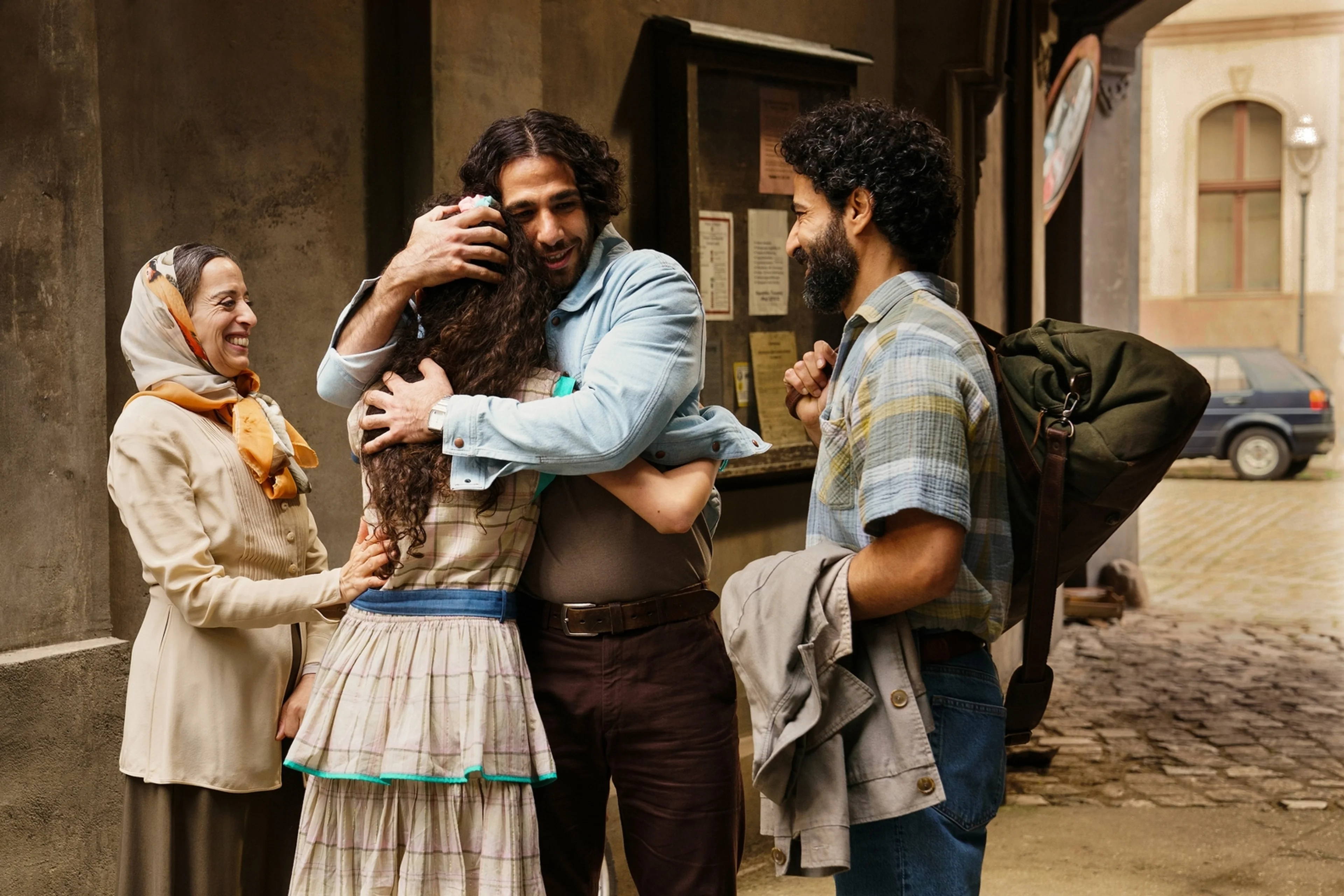 Members of the Hamady family embrace outside a Berlin apartment building in 4 Blocks Zero Episode 1.