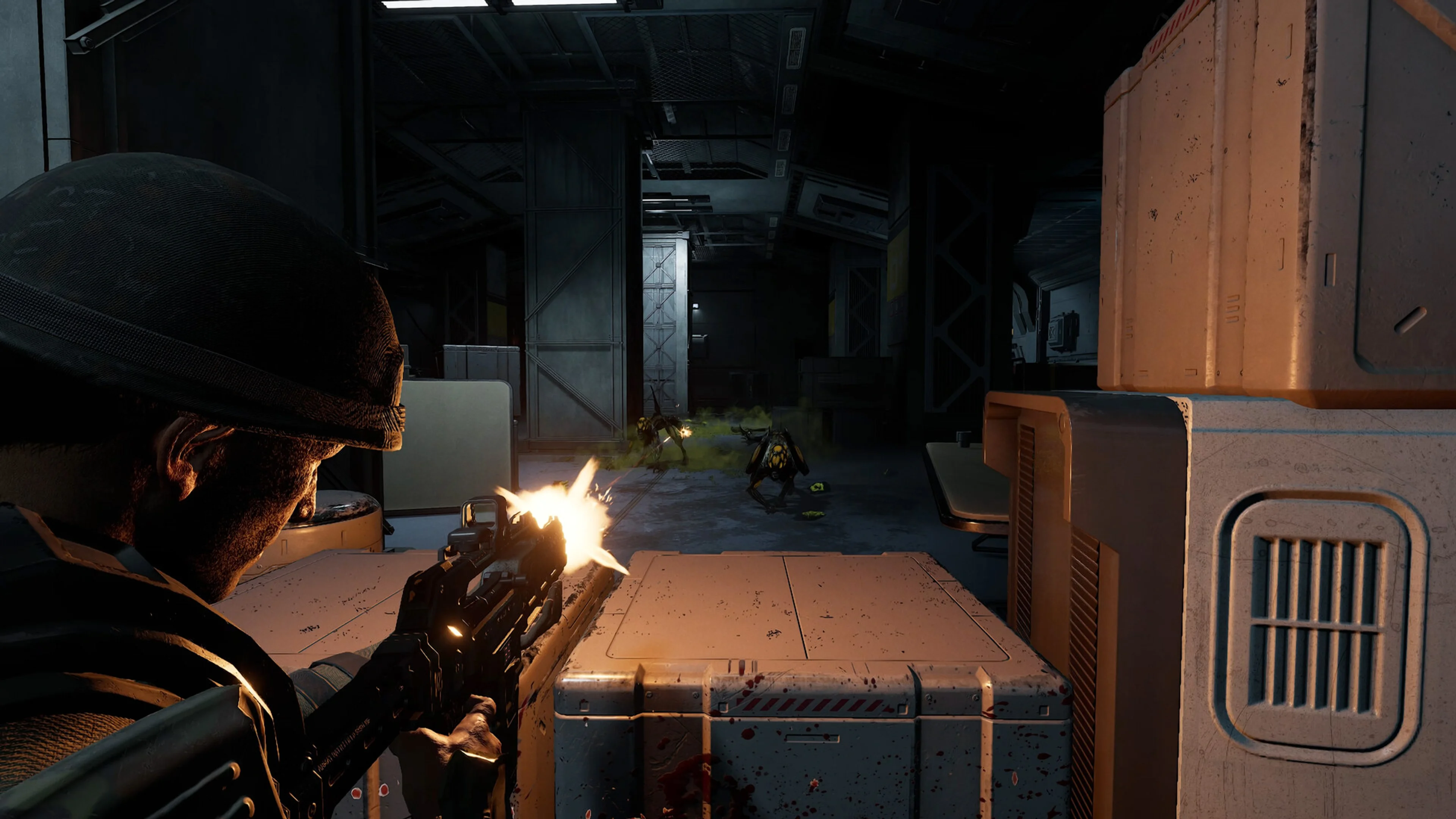 A marine shoots down a corridor while teammates fight nearby.
