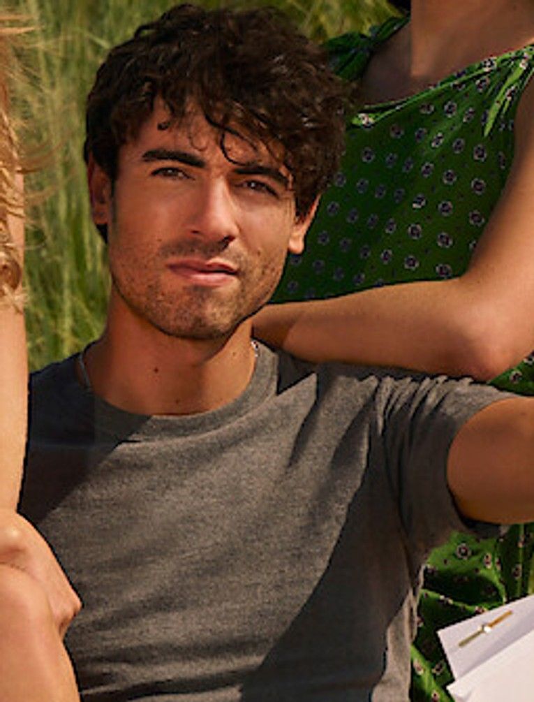 Roby Attal in a gray T-shirt in the official This Summer Will Be Different cast photo.