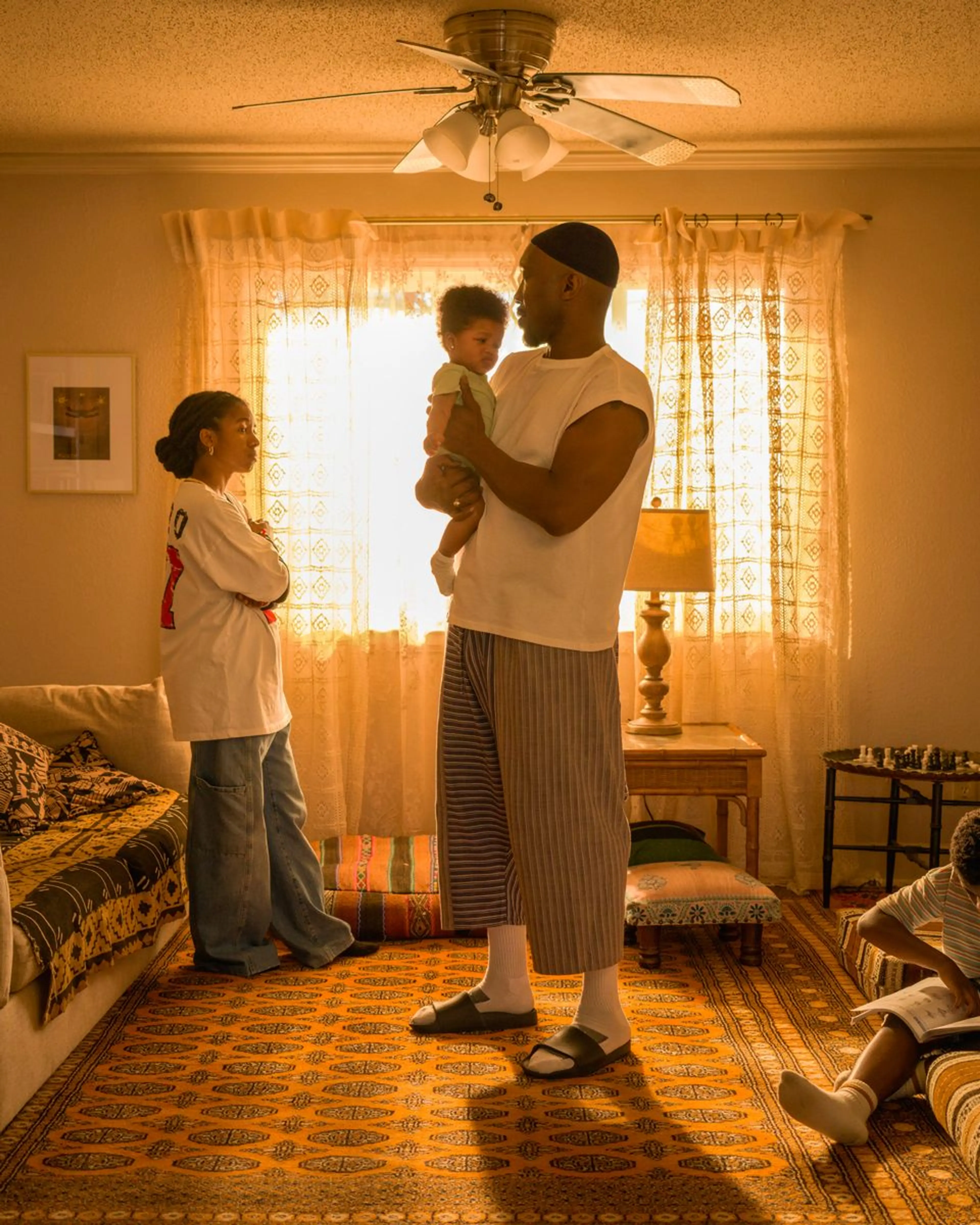 Mahershala Ali as Latif holds his infant child.
