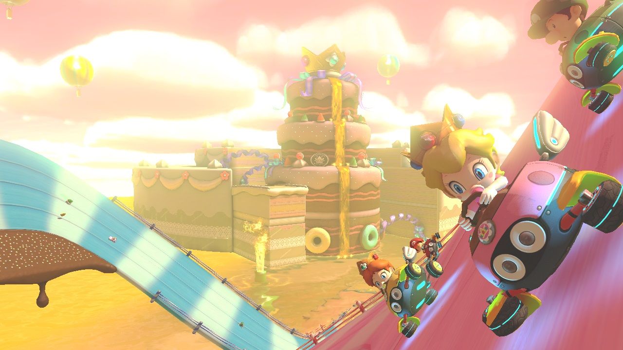 Peach and other racers travel around a curved wall beside a desert-colored course.