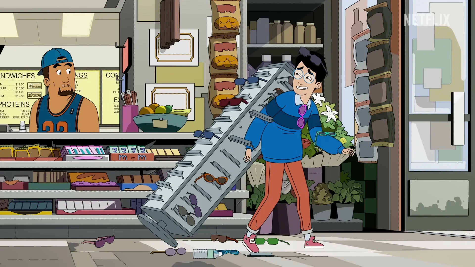 Andrew crashes into a product display during a store scene in DANG!.