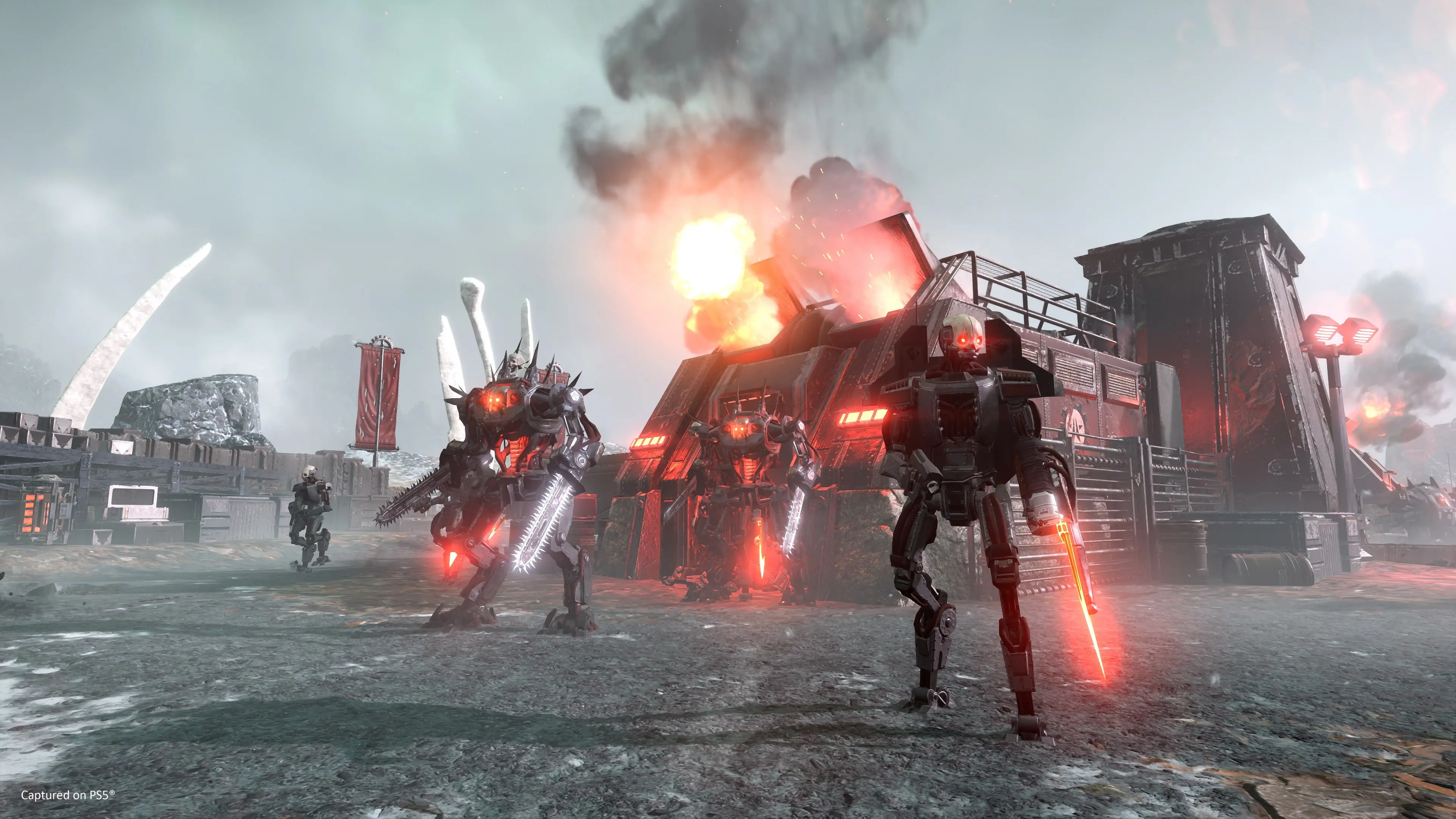 Automaton soldiers advance from a red-lit outpost while Helldivers attack in the distance.