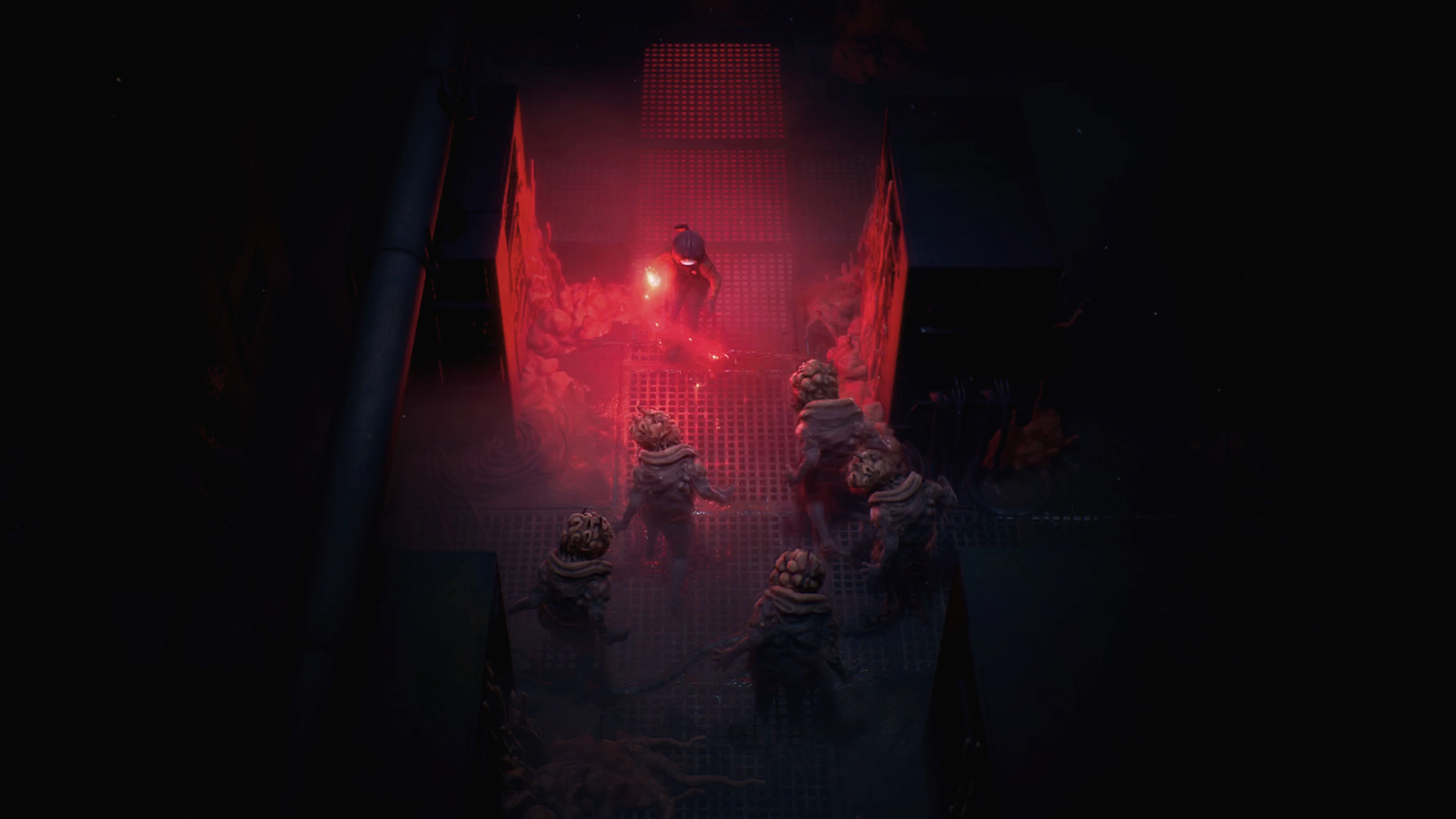 Cel fights monsters under red emergency lights.