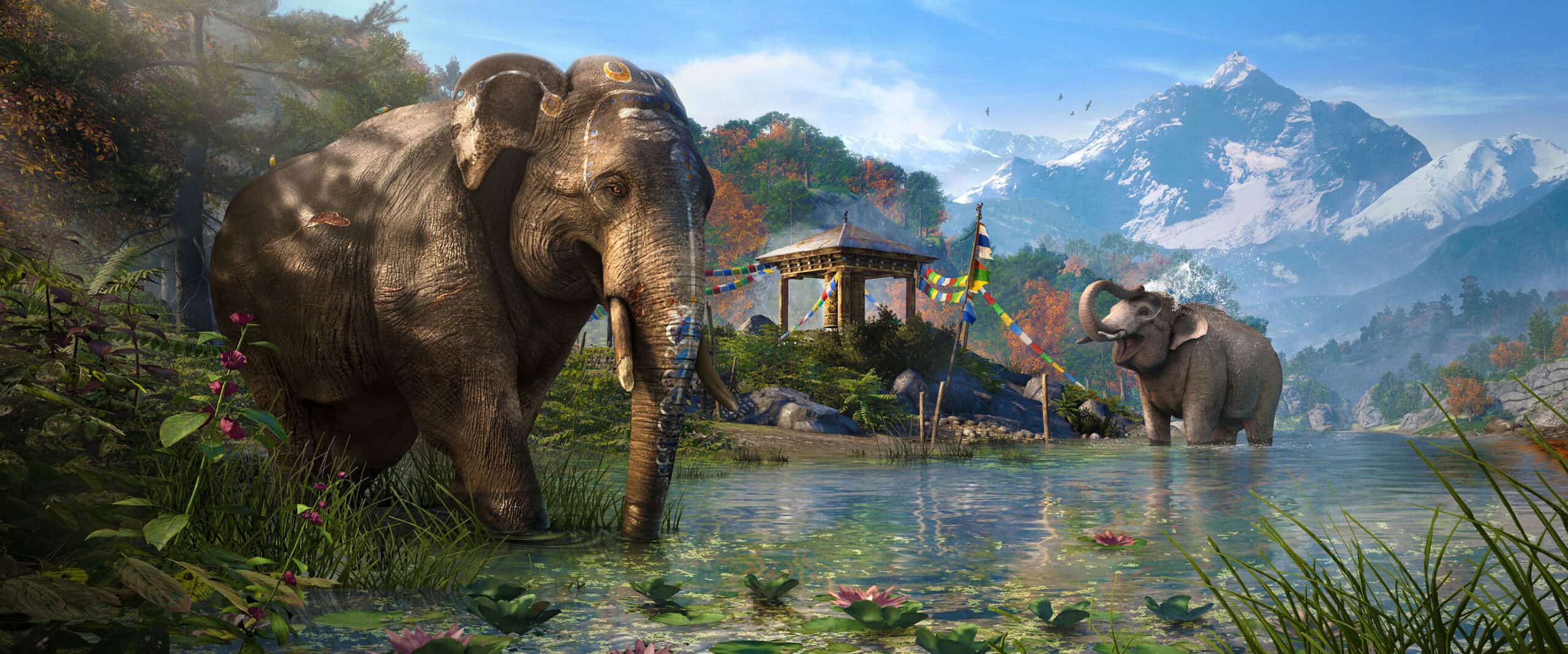 Elephants stand in a river with the mountains of Kyrat behind them.