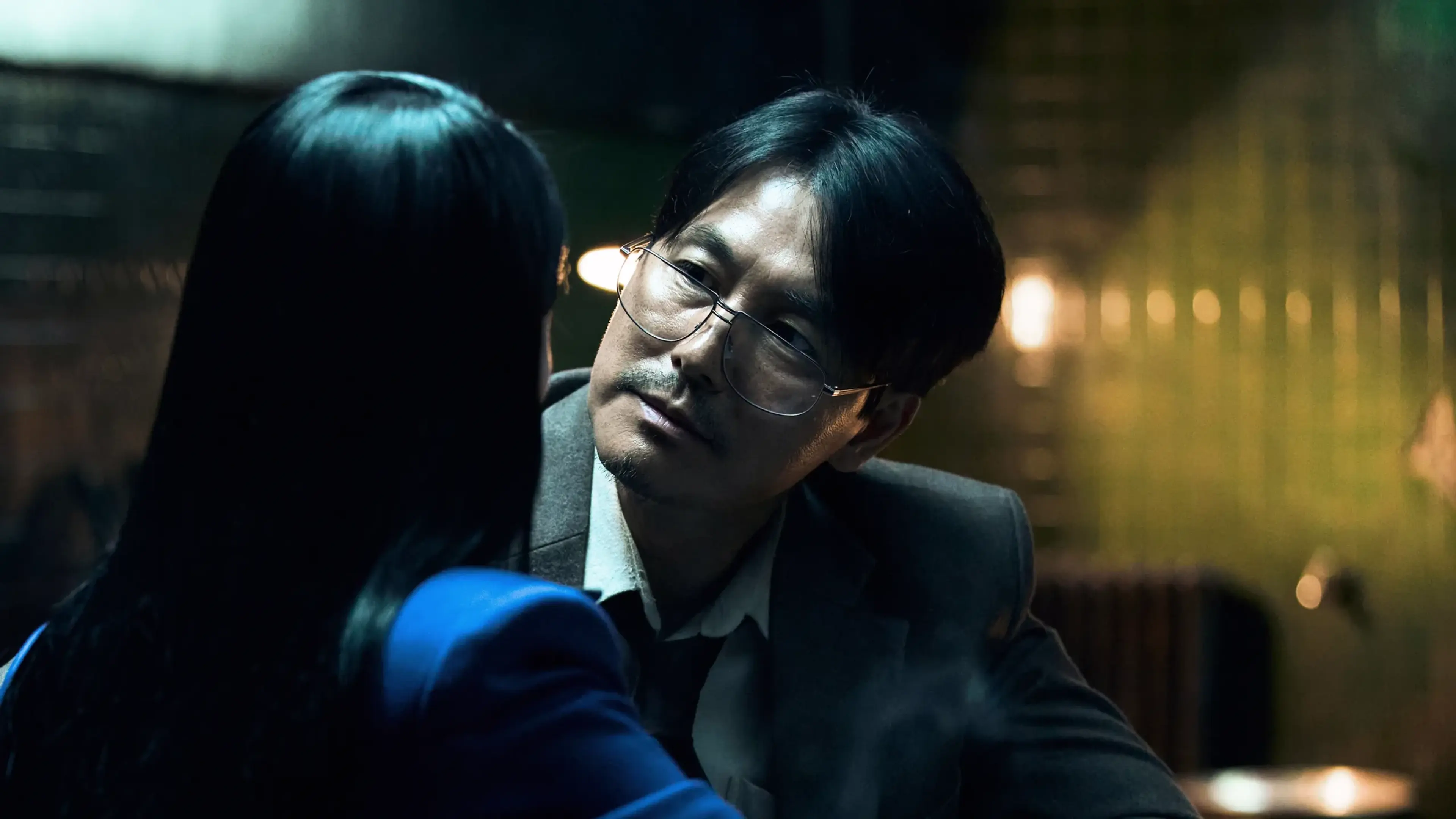 Geon-young leans toward Ye-jin, who is seen from behind in a blue jacket.