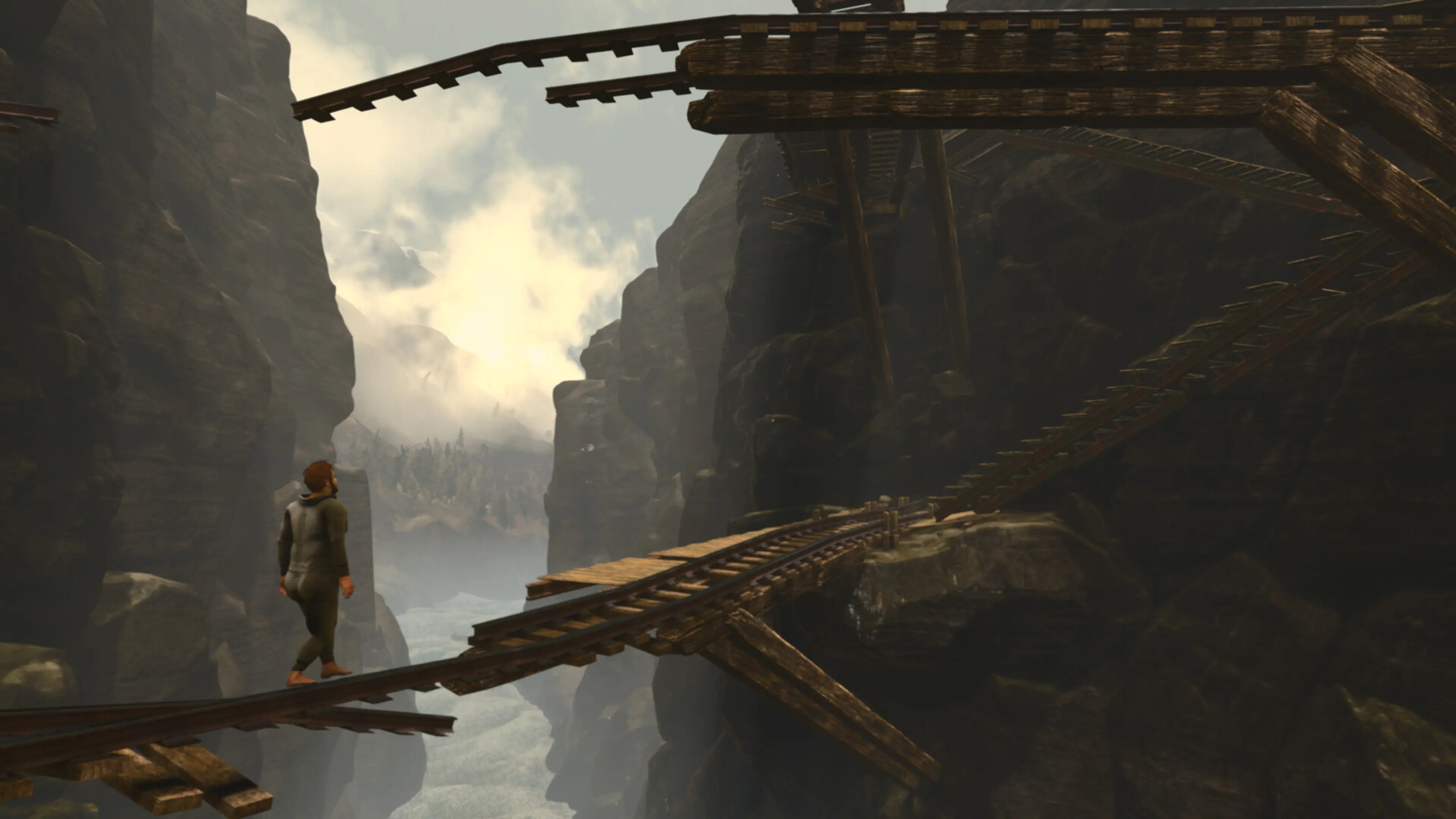 Nate walks across broken railway tracks suspended over a canyon in Baby Steps.