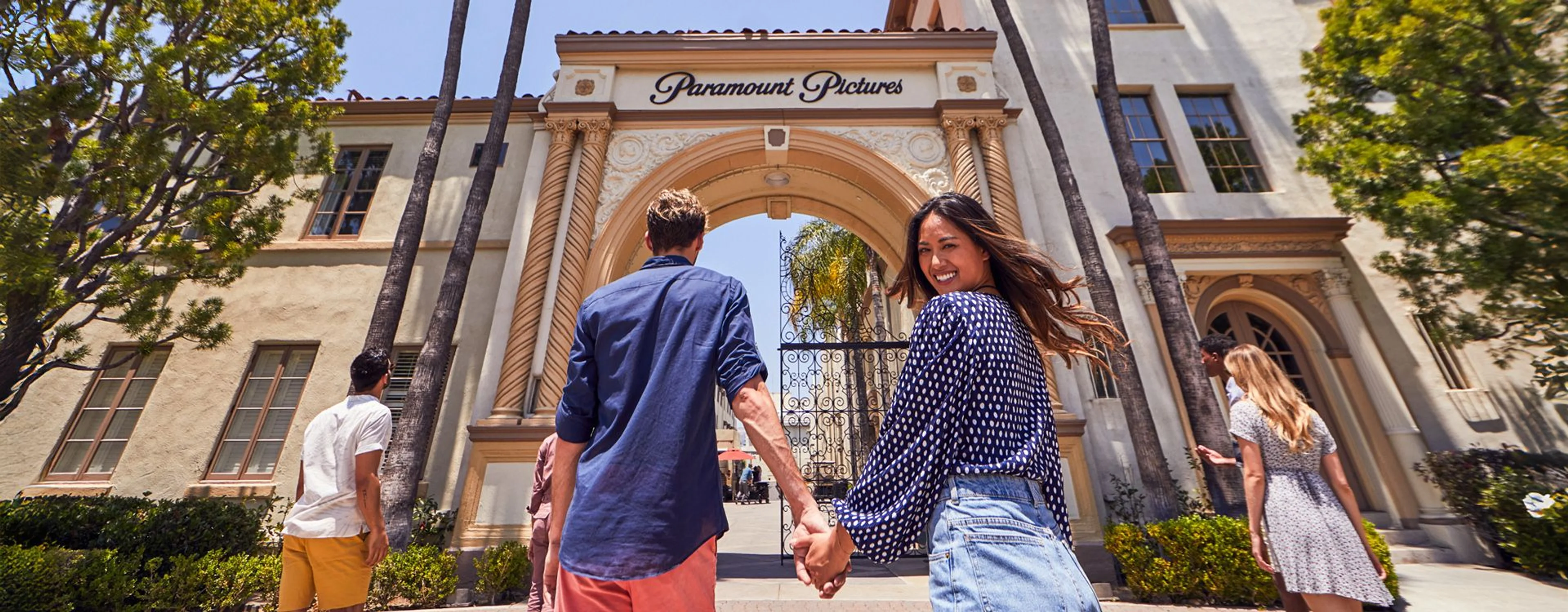 Visitors walk through the Paramount Pictures studio gate in Los Angeles.