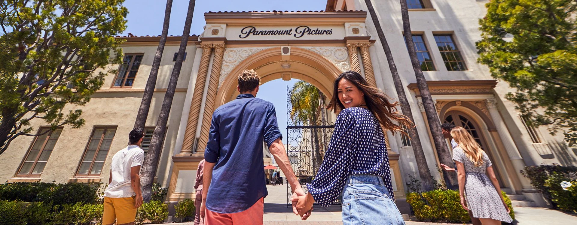 Visitors walk through the Paramount Pictures studio gate in Los Angeles.