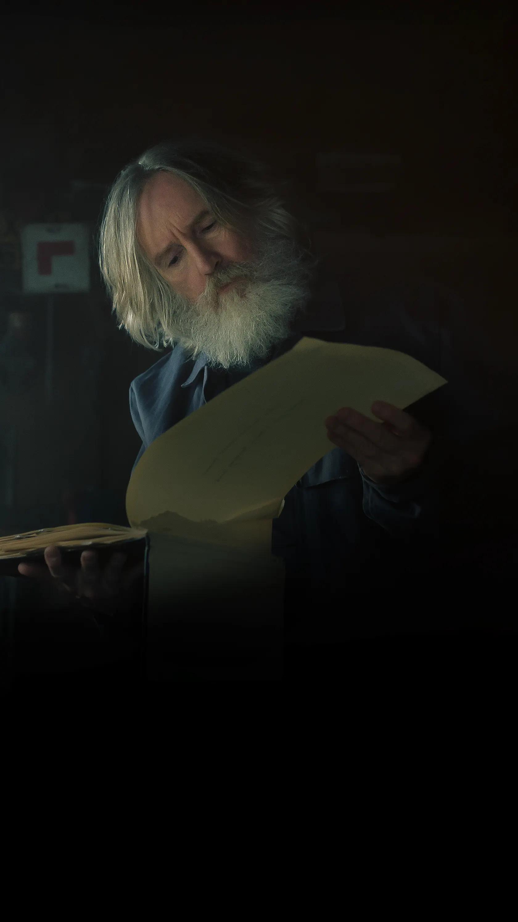 Michael Sleep reads an old journal in the Small Prophets Apple TV cover.