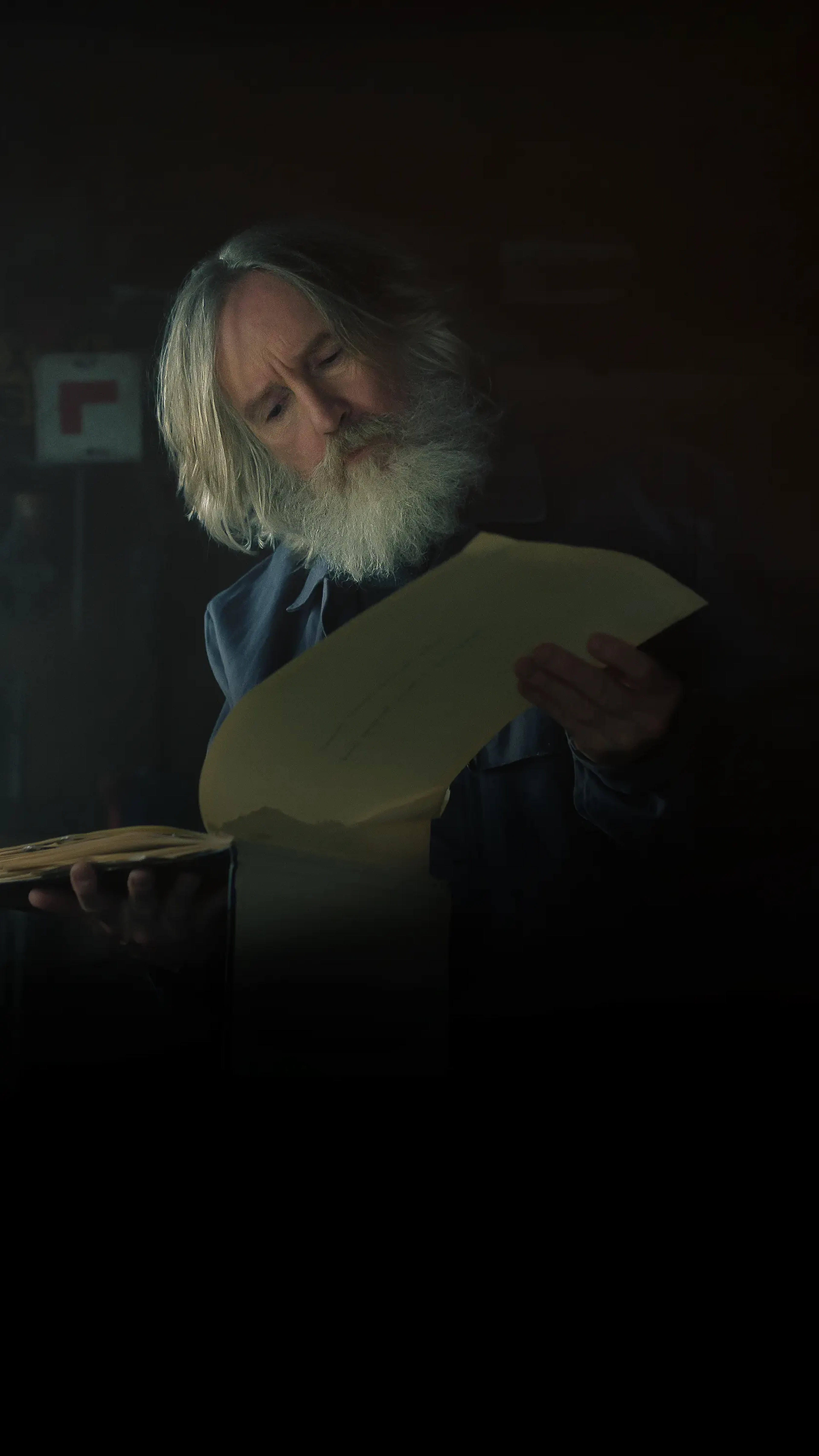 Michael Sleep reads an old journal in the Small Prophets Apple TV cover.