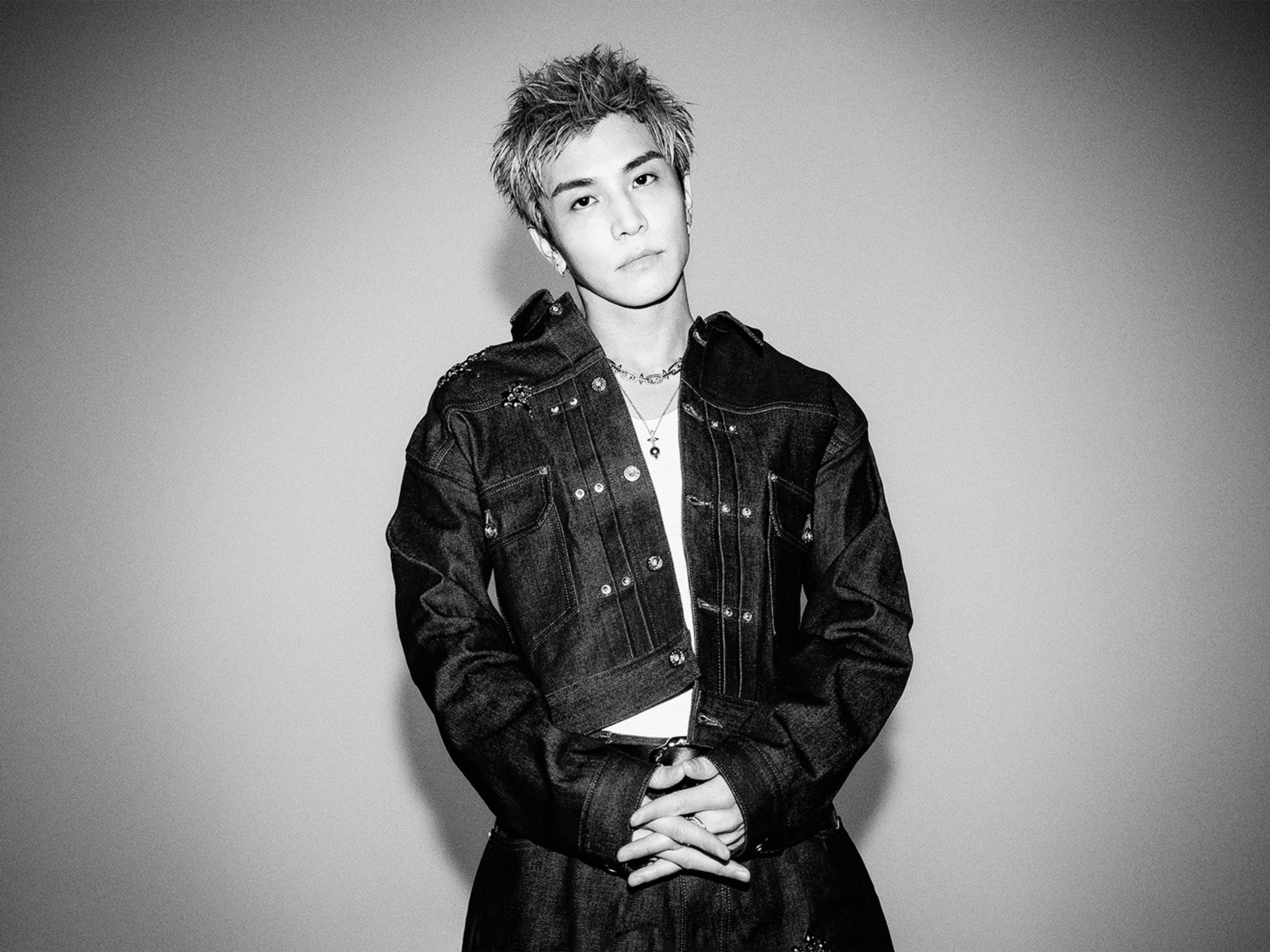 GAN poses in a dark jacket in the official Season 2 opening-theme artist photo.