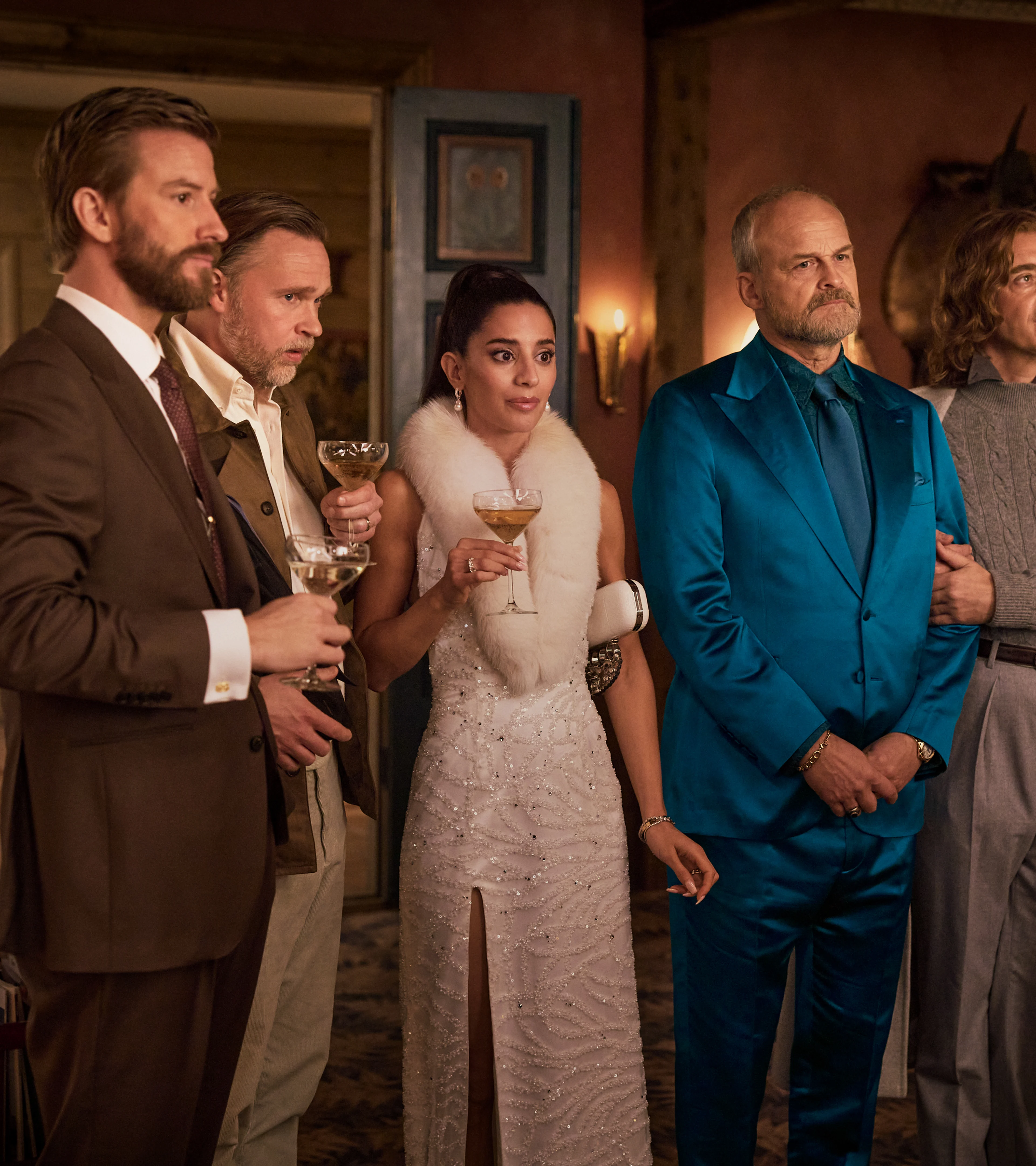 Guests stand together inside the farmhouse during a scene from The Storm.