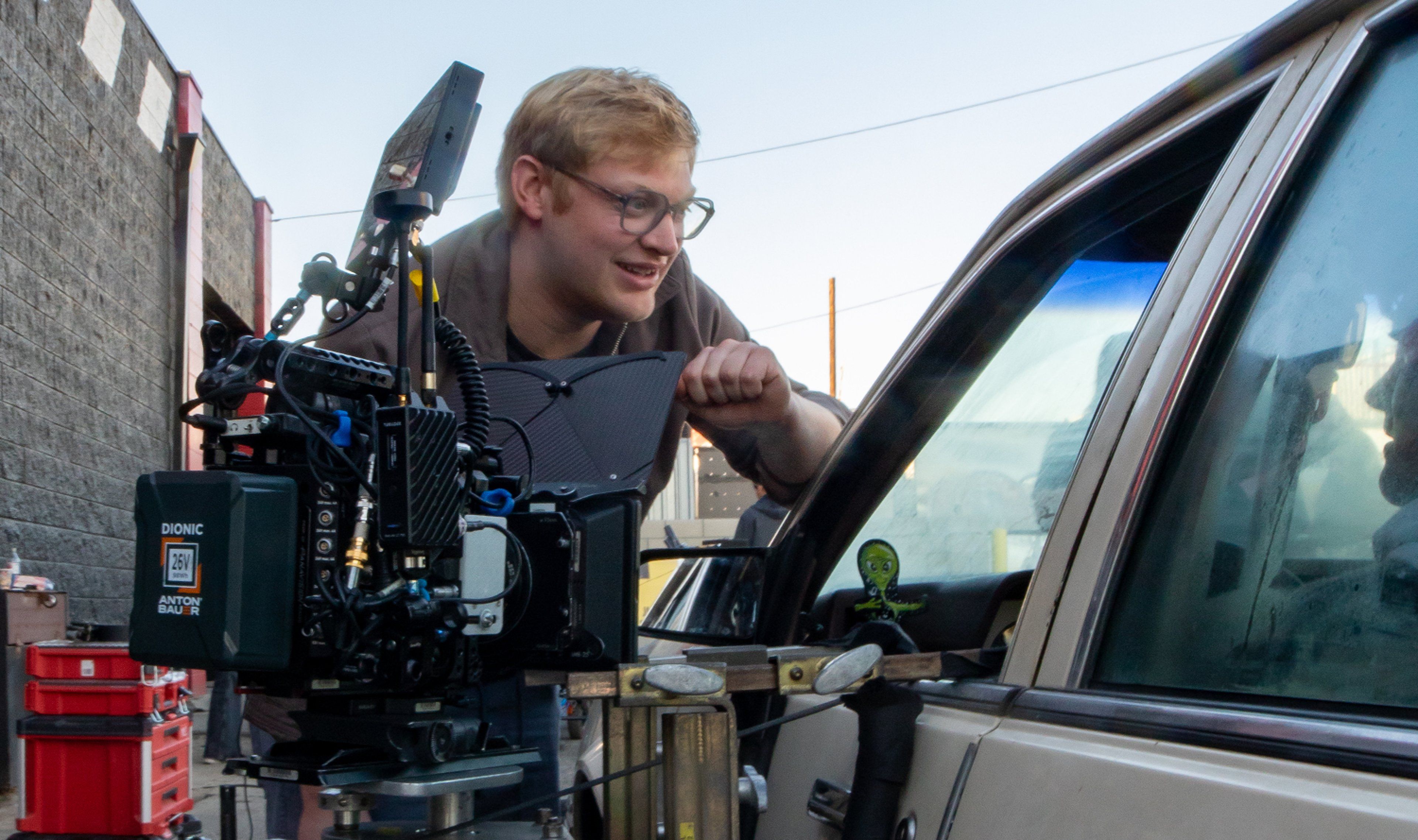 Curry Barker leans over a camera while filming Obsession.
