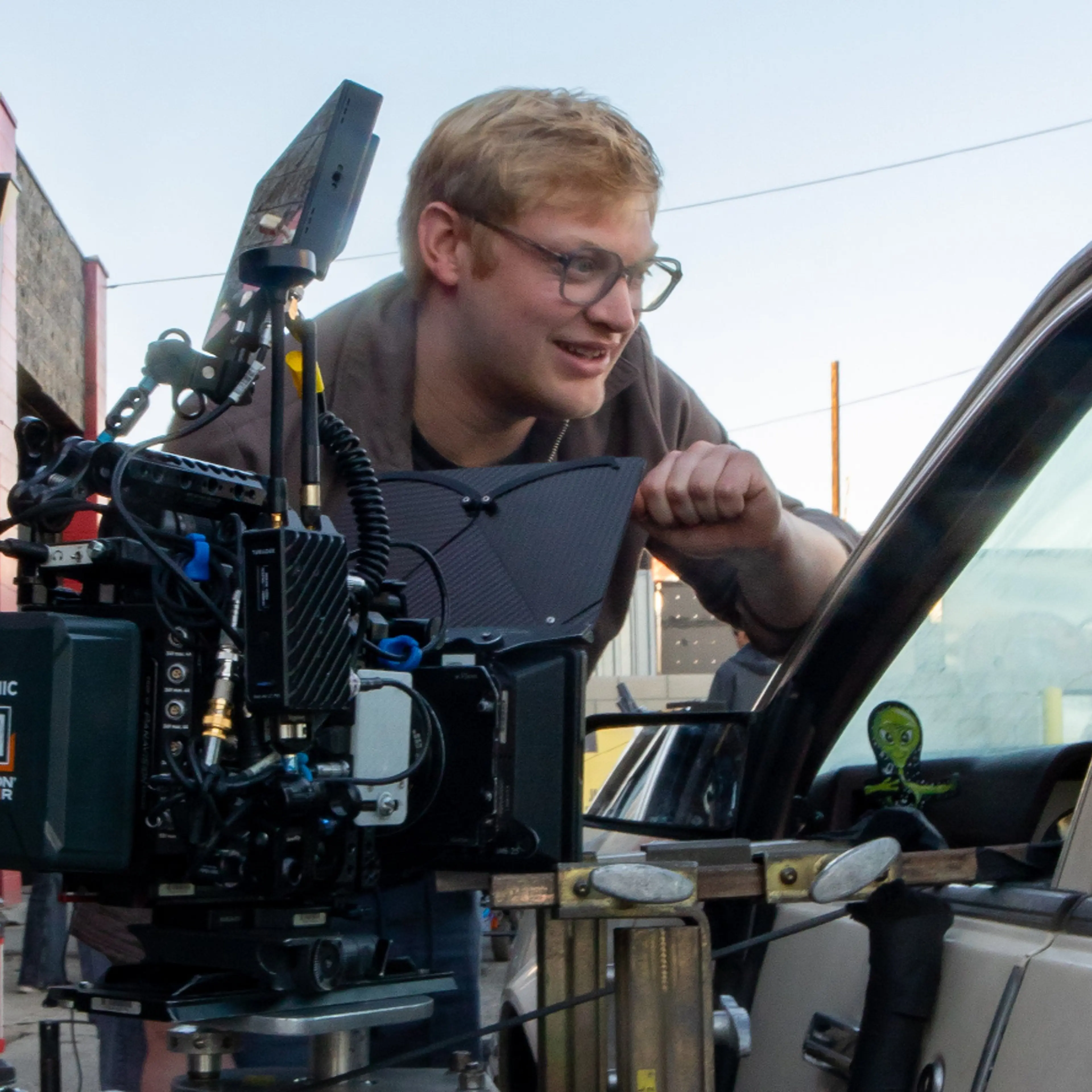 Curry Barker leans over a camera while filming Obsession.