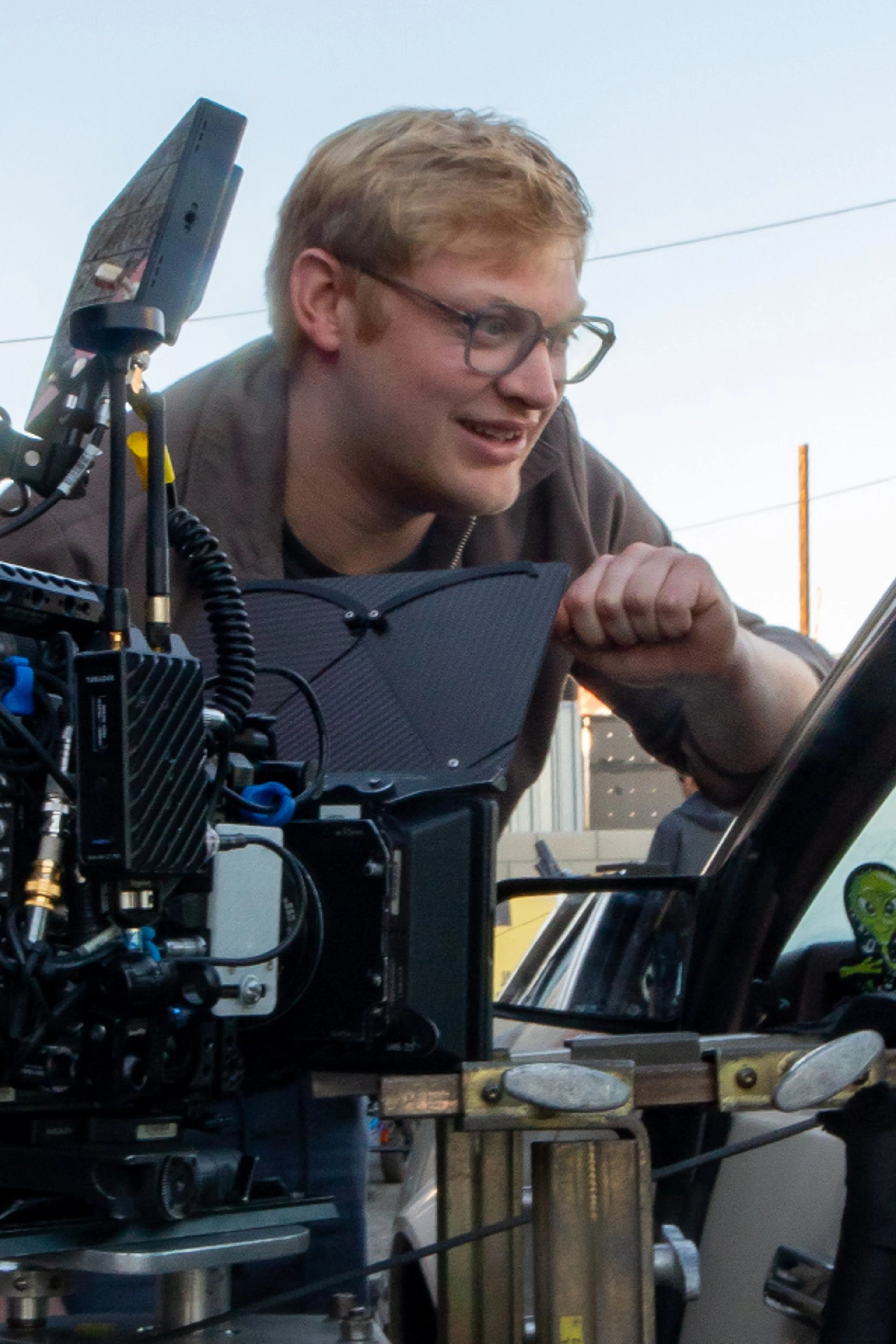 Curry Barker leans over a camera while filming Obsession.