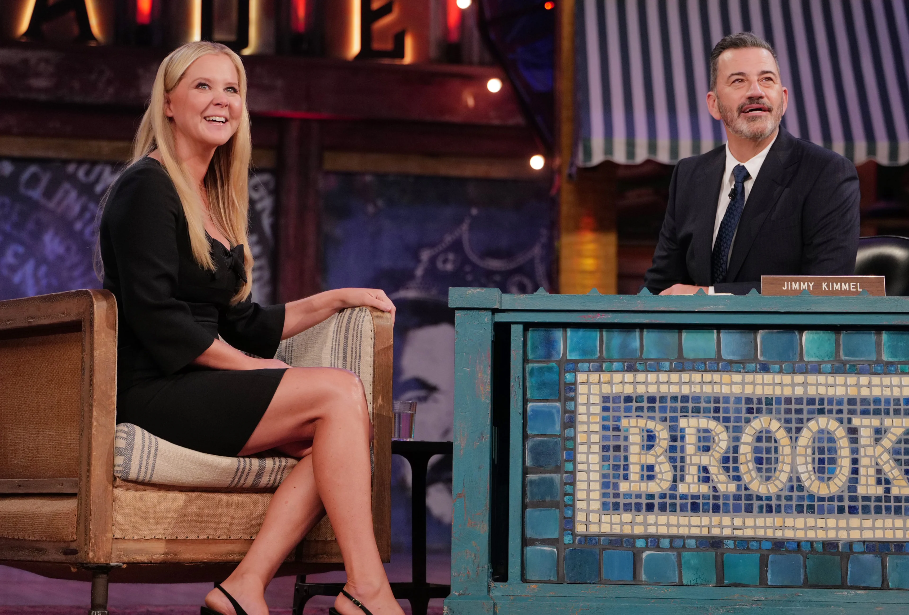 Amy Schumer and Jimmy Kimmel look upward during their Brooklyn interview.