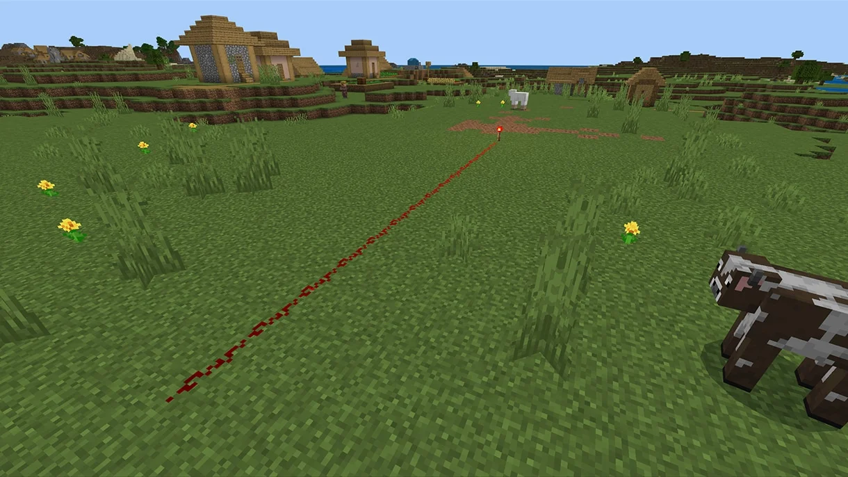 An official Minecraft demonstration of redstone dust becoming darker as a signal travels away from a torch.