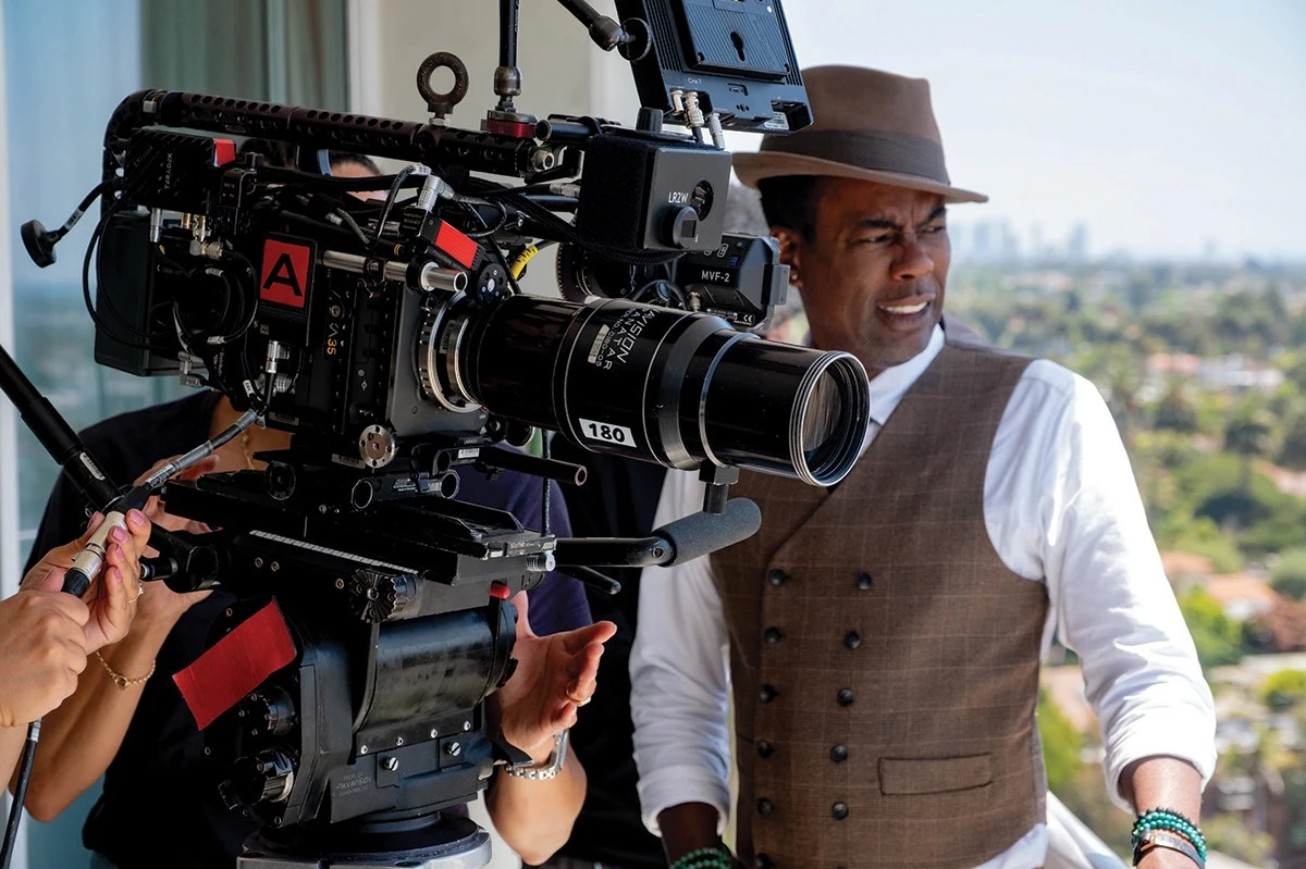 Chris Rock on location for Misty Green, standing behind the camera with crew nearby.