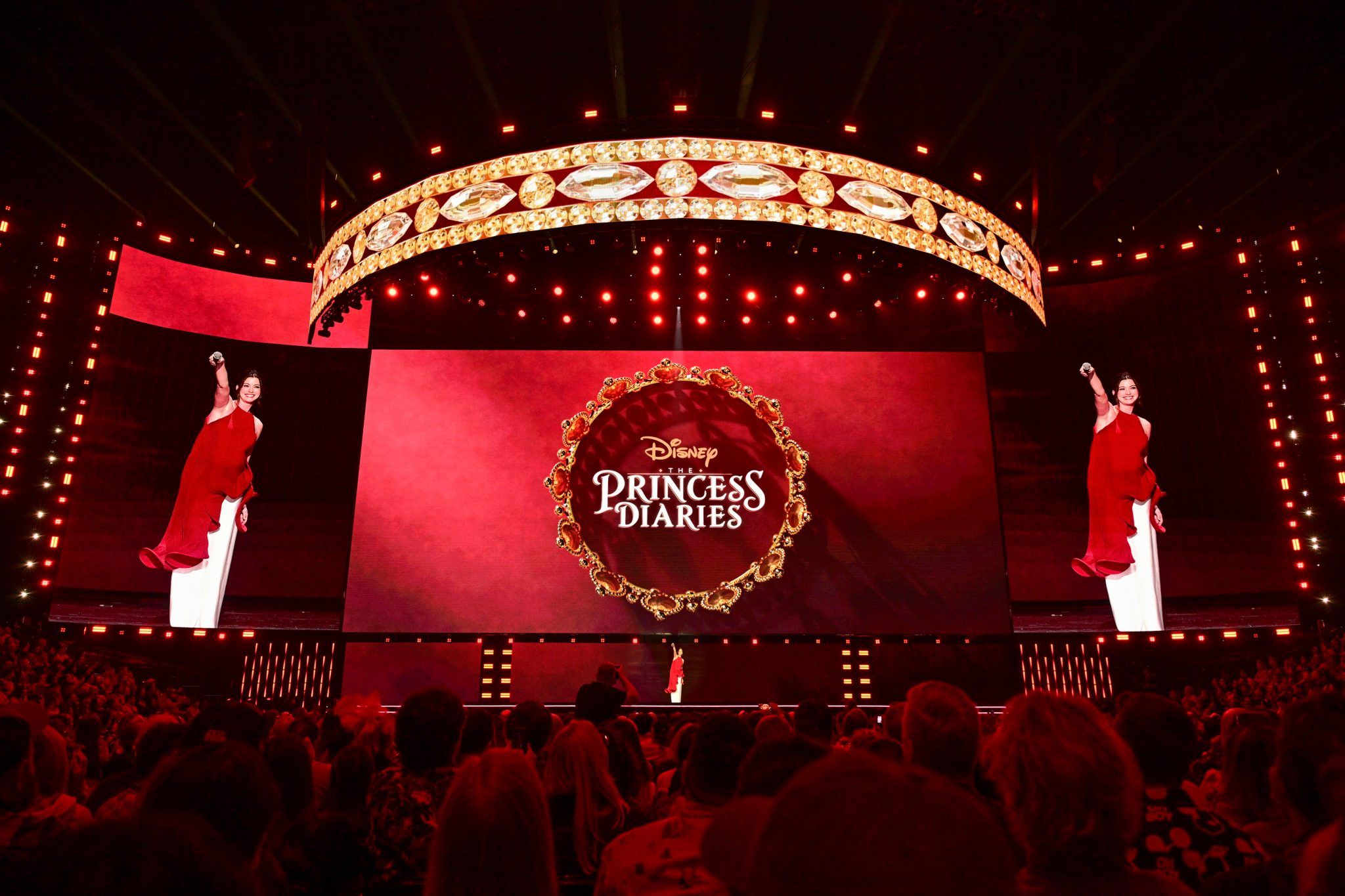 Anne Hathaway appears onstage at D23 2026 beneath The Princess Diaries logo.