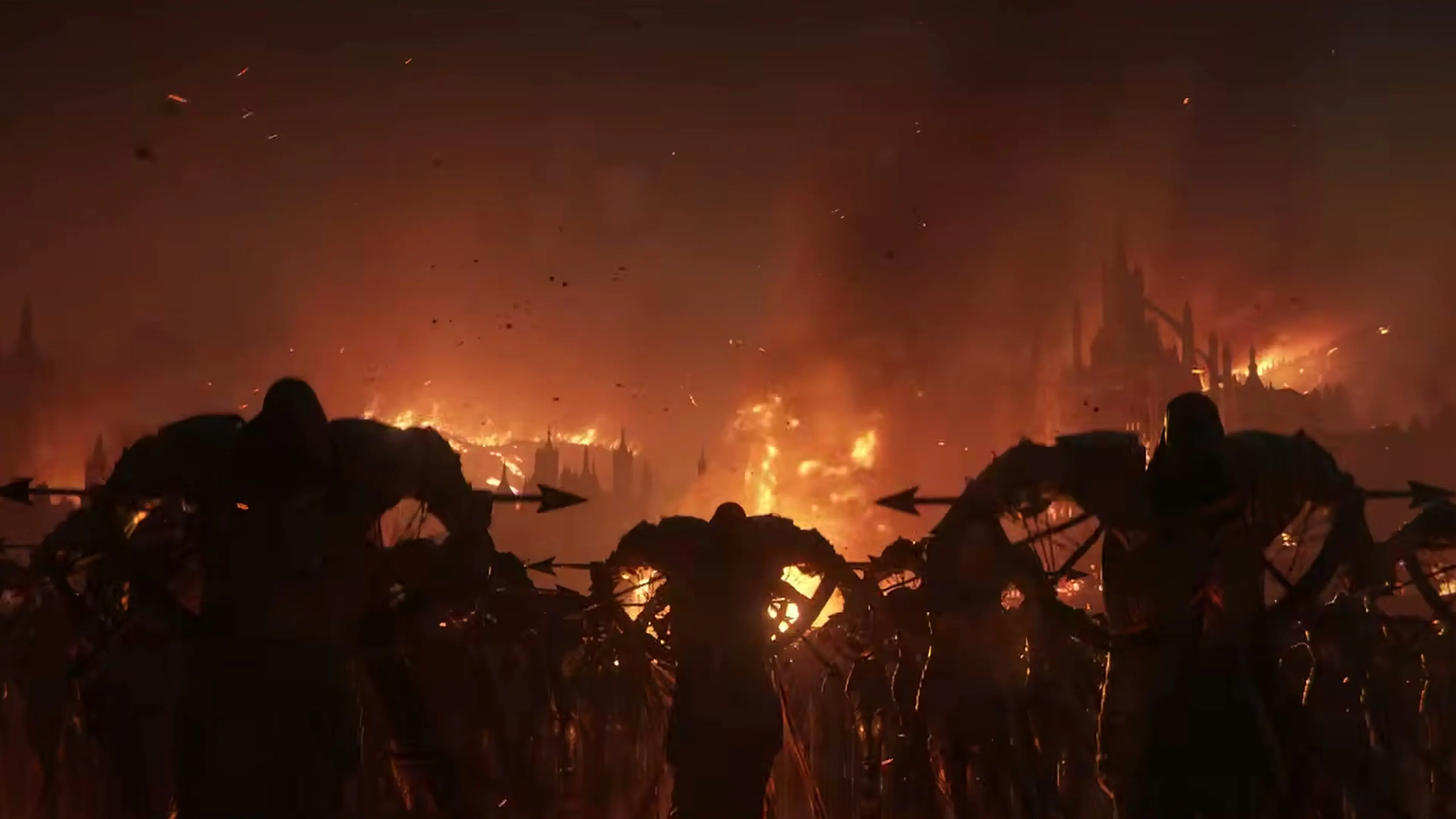 Rows of dark fallen figures stand before a city burning under a red sky.