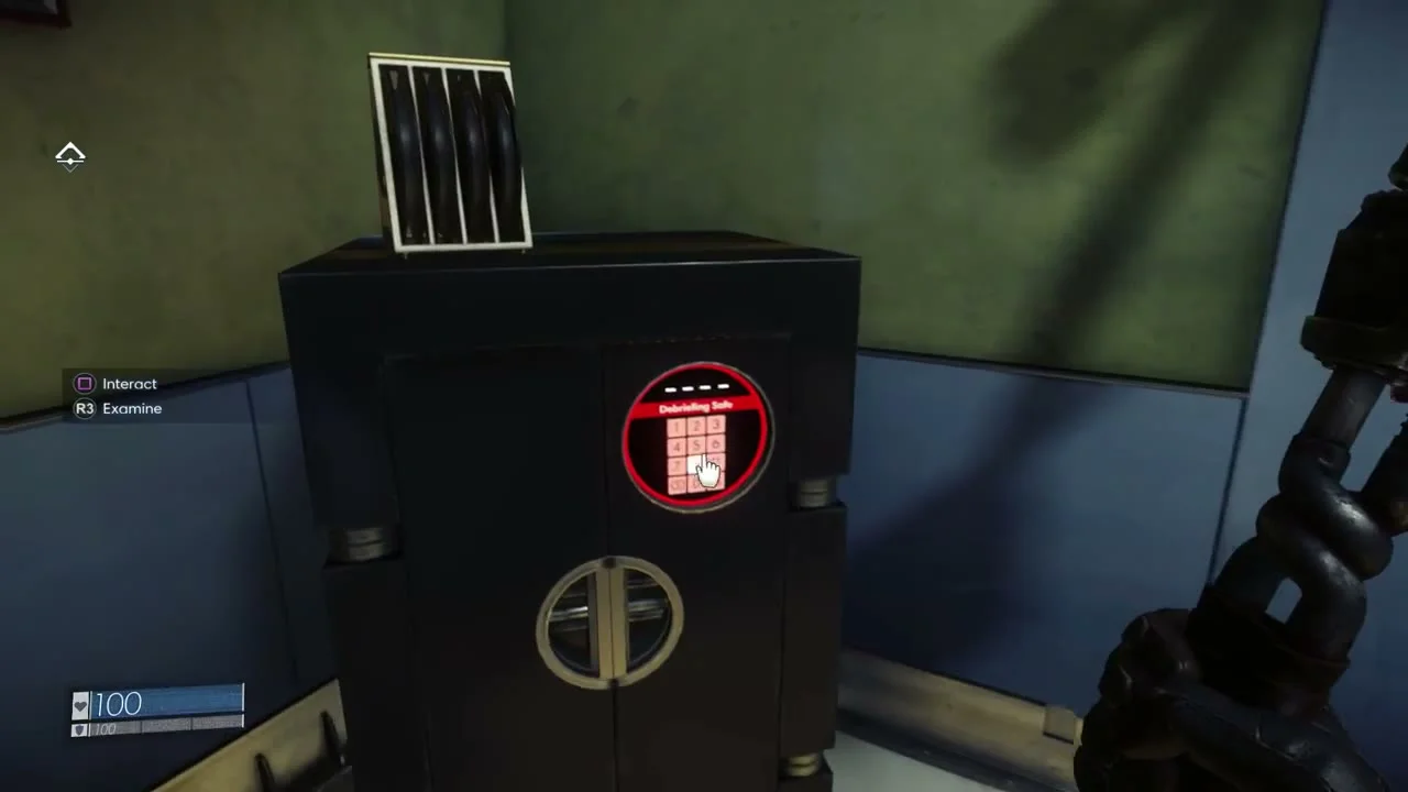 A dark safe with a red keypad and the label Debriefing Safe.