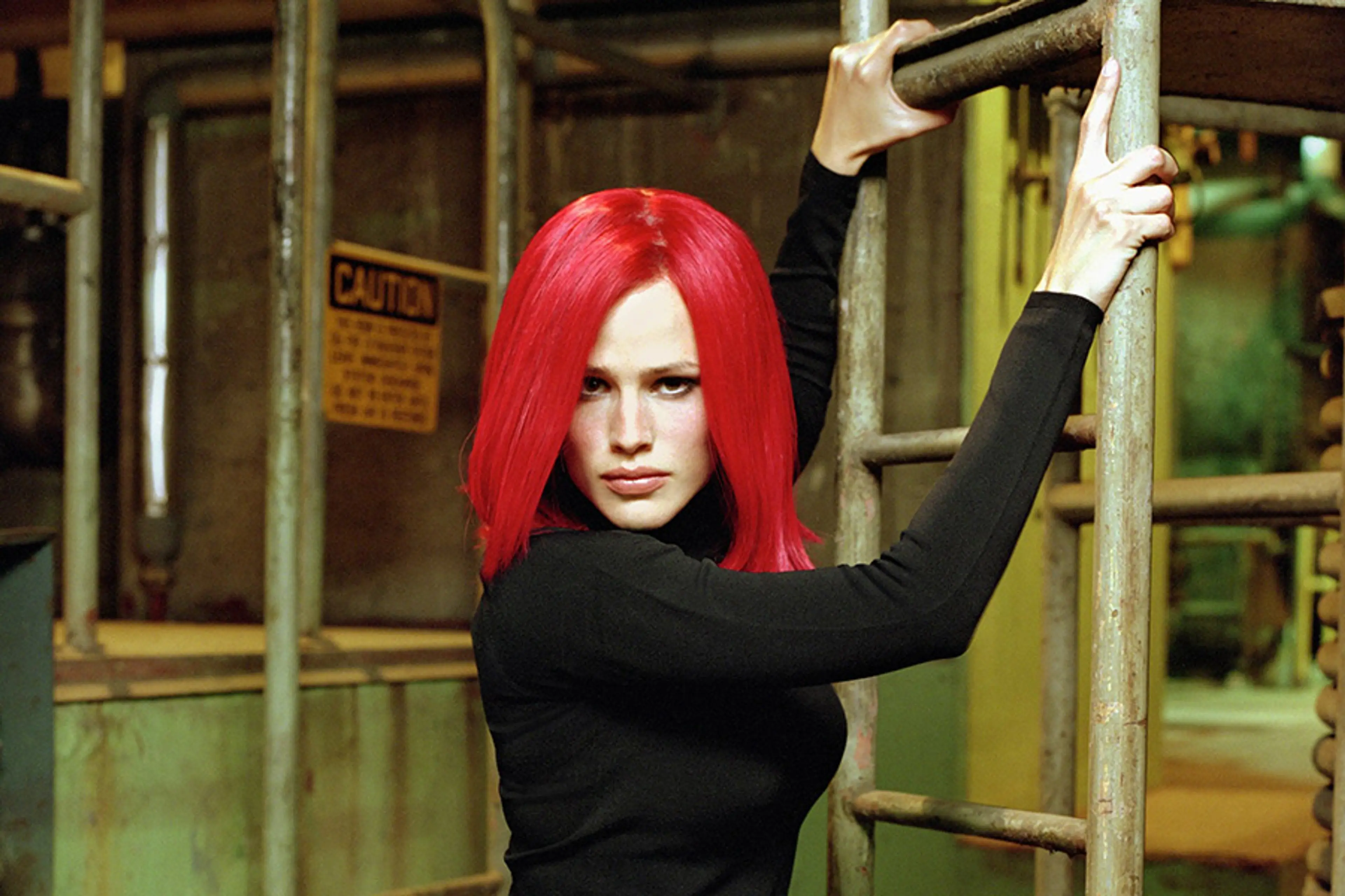 Jennifer Garner wears a red wig and holds a ladder in the Alias pilot.